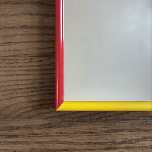 Accent Mirror With an MCM-style Blue/Red/Yellow/Teal Metal Frame.